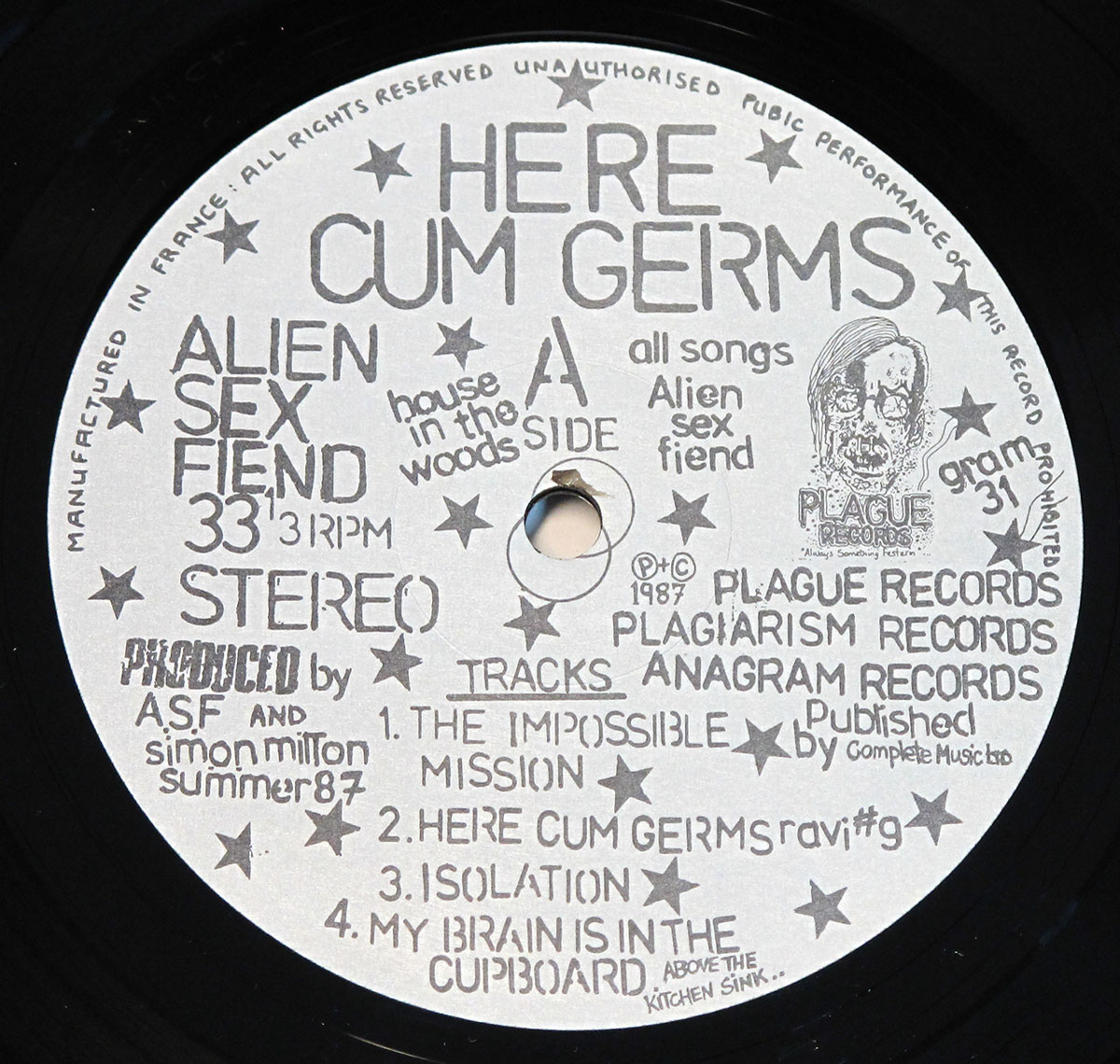 Side A record label of Alien Sex Fiend's Here Cum Germs LP showing handwritten-style text, tracklist, and Plague Records logo with skull artwork.